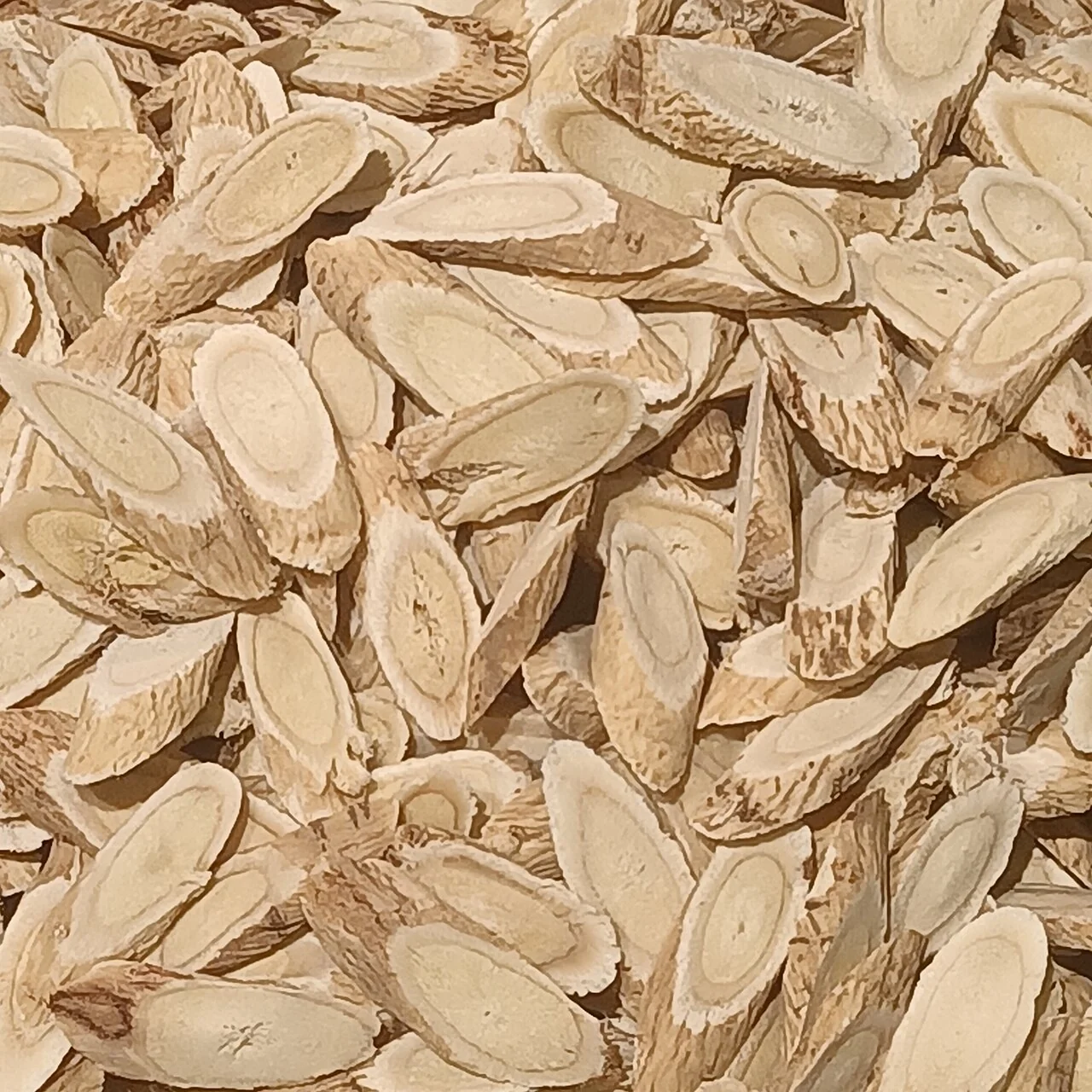 Dried slices identified by the source as Astragalus mongholicus; botanical material reference, not the offered extract.